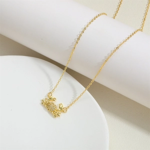 Golden crab pendant necklace with sparkling rhinestones and thin minimalist chain
