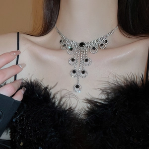 Detail of luxury fringe necklace with black gemstones and sparkling silver rhinestones