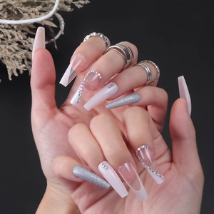 Long coffin press-on nails with silver glitter, white French tips, and rhinestone accents