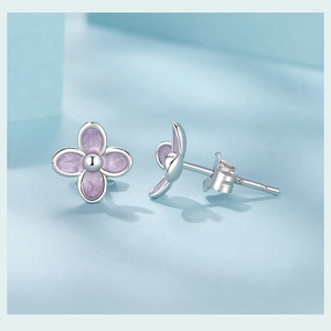 Macro shot of purple S925 sterling silver four-leaf flower stud earrings detail