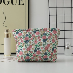 Floral quilted toiletry bag with delicate flower pattern shown in a stylish setting