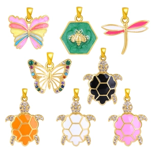 Golden insect and sea turtle charms set with colorful enamel and sparkling crystals