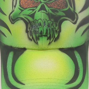 Close-up of skull baseball cap with fluorescent gradient and orange sequin eyes detail