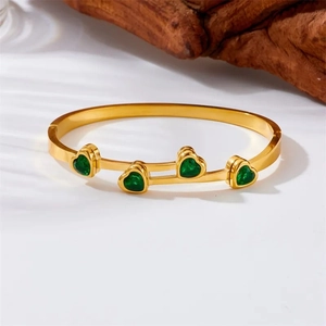 Elegant gold titanium steel bracelet with four heart-shaped green zircons in polished finish