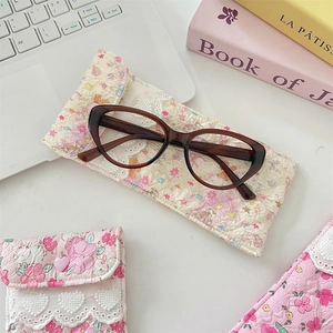 Detail of floral quilted cotton glasses pouch with soft protective lining and elegant pattern