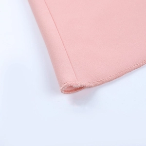 Close-up of pink long-sleeved dress showing precise stitching and fabric texture
