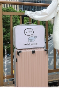 Travel bag with back sleeve sliding over pink luggage handle showing portable design