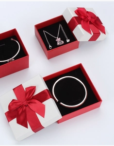 Detailed view of jewelry set with necklace and bracelets in a red ribbon gift box