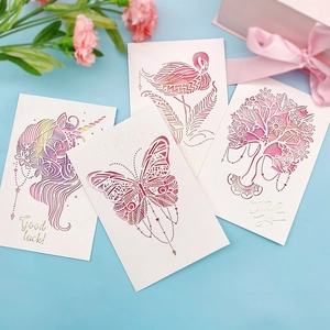 Detailed view of 3D laser-cut greeting cards with gold foil and watercolor motifs