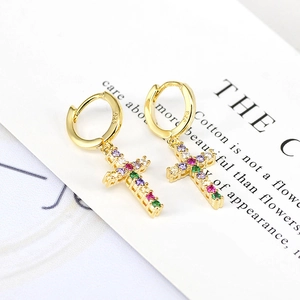 Macro shot of gold cross earrings featuring colorful zircons and 925 silver hallmark