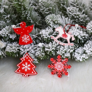 Christmas painted wooden ornament set with angel and reindeer on snowy pine branch
