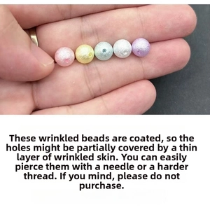 Close-up of five-color textured ABS faux pearls with center holes for DIY jewelry making