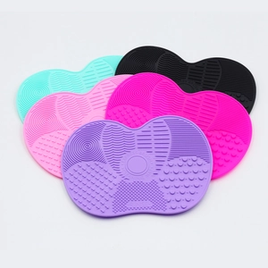 Detailed view of multi-textured silicone makeup brush cleaning mats in five vibrant colors