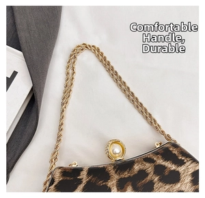 Detail of leopard print shell bag featuring a large pearl clasp and golden rope chain
