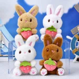 Detailed view of four colorful plush rabbit keychains holding pink strawberries