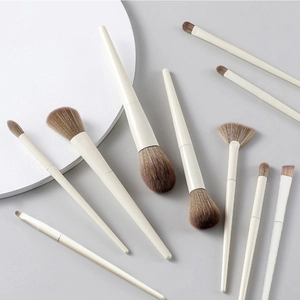 10-piece professional makeup brush set with beige handles and soft brown bristles
