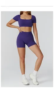 Detail shot of navy blue seamless yoga set with cropped short sleeve top and high waist shorts