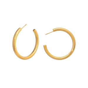 Macro shot of gold-plated stainless steel C-shape hoop earrings on a white background