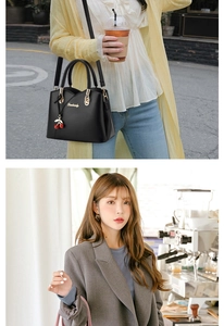 Chic women's top-handle bag in black and pink with gold hardware and cherry charm