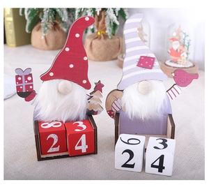 Macro detail of wooden Christmas gnome perpetual calendars with date blocks on a desktop