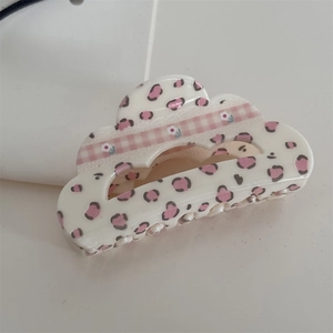 Detail of pink leopard and floral plaid pattern on cloud-shaped acrylic hair claw clip