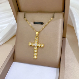 Detailed close-up of a gold-plated titanium steel cross pendant necklace with zircon stones