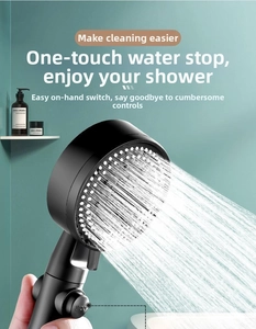 Detail of matte black pressurized handheld shower head with a water-stop button