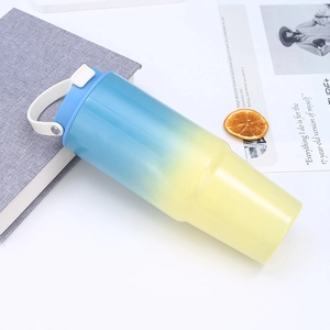 Close-up of 30oz blue and yellow gradient stainless steel tumbler with handle and lid