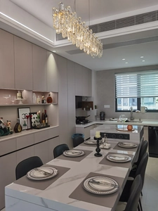 Modern dining room scene with leather placemats on marble table under crystal chandelier
