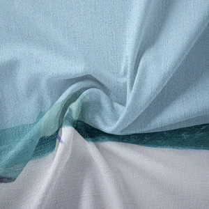 Macro detail of Bohemian tapestry fabric showing blue and white abstract print texture