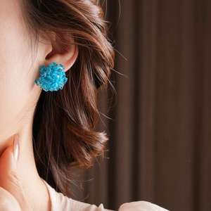 Close-up of elegant blue crystal bead flower earrings on model with refined details
