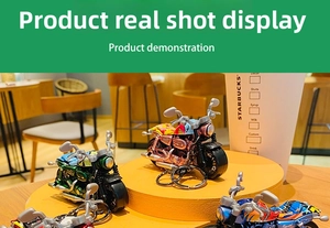 Detailed close-up of three colorful cartoon alloy motorcycle keychain pendants on a stand