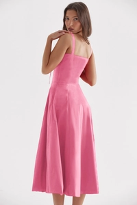 Detail of pink silk-texture midi dress showing back silhouette and fabric sheen