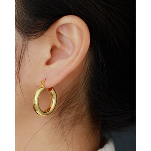 Classic gold S925 sterling silver chunky hoop earrings for women shown on a model
