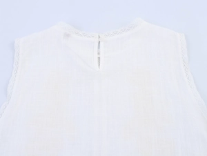 Detail of the white lace trim collar and textured linen-cotton fabric on the sleeveless top