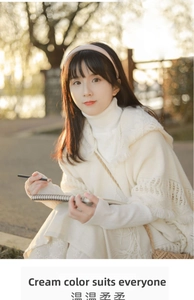 Detailed knit texture and fringe edge of this bohemian cream white hooded poncho