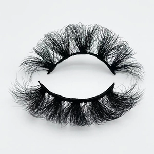 Macro detail of 20mm faux mink eyelashes with thick Russian volume and messy curl style