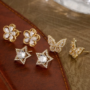 Three pairs of elegant gold-plated flower, butterfly and star stud earrings with cubic zirconia