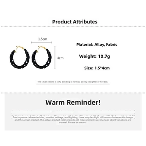Detail view of fabric wrapped hoop earrings with polka dot pattern and 4cm diameter size