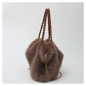 Detail of brown faux fur bucket bag featuring woven PU handles and gold metal chain strap