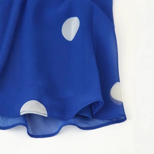 Royal blue halter midi dress with white polka dots featuring delicate hemline details