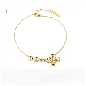 Detailed view of gold stainless steel anklet with coin charms and small bell pendant