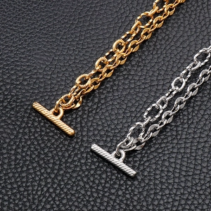 Detail of gold and silver double-layered stainless steel chains with OT toggle clasp