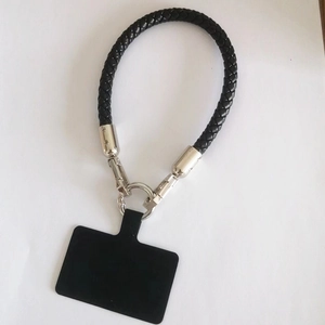 Detail of black braided leather phone lanyard with metal spring ring and connector