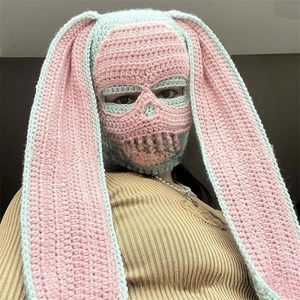 Detail of handmade crochet skull balaclava featuring long bunny ears in pink and green