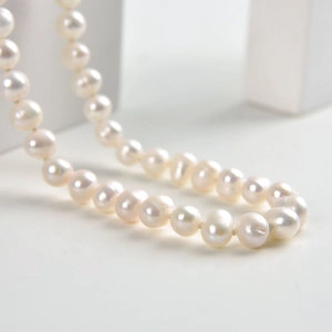 Close-up of premium freshwater pearls with natural luster and minimalist 925 silver clasp
