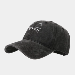 Detailed view of white cat whiskers embroidery on washed cotton charcoal baseball cap
