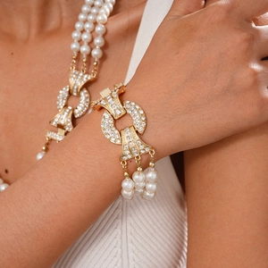 Vintage gold layered necklace and bracelet set with pearls and rhinestones on a model