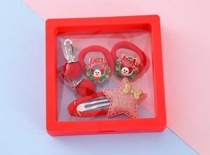 Detailed view of kids Christmas hair accessories in a red square gift display box