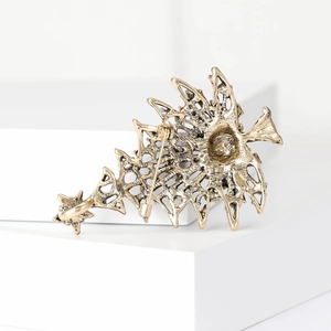 Vintage gold hollow Christmas tree brooch back view showing secure safety pin and alloy texture